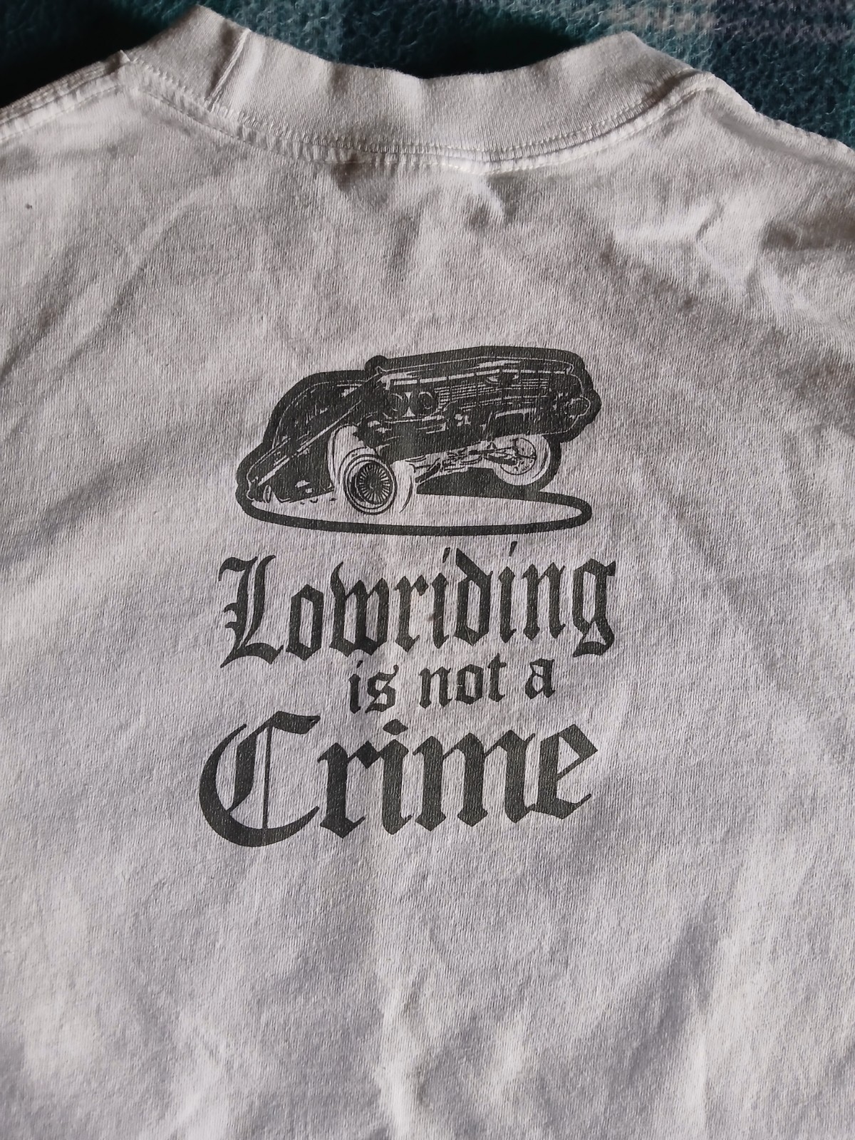 T-Shirt “Lowriding is not a Crime” design printed on a Shaka Wear blank Size L