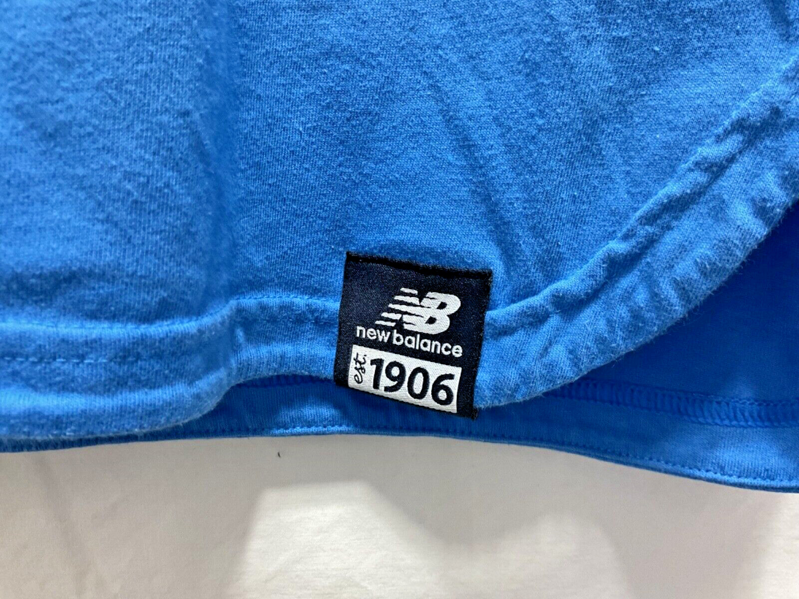 NB New Balance Stretch Blue Pocket T Shirt Unisex size Small Round Slit Hemline