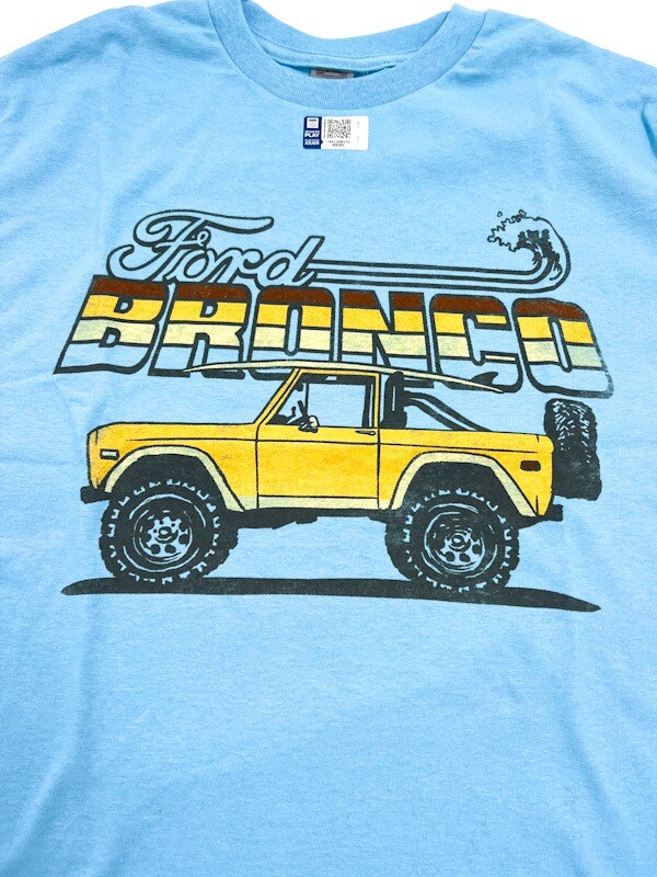 Sky Blue T-Shirt – Yellow Ford Bronco Beach Surfboard Scene w/ Script Emblem