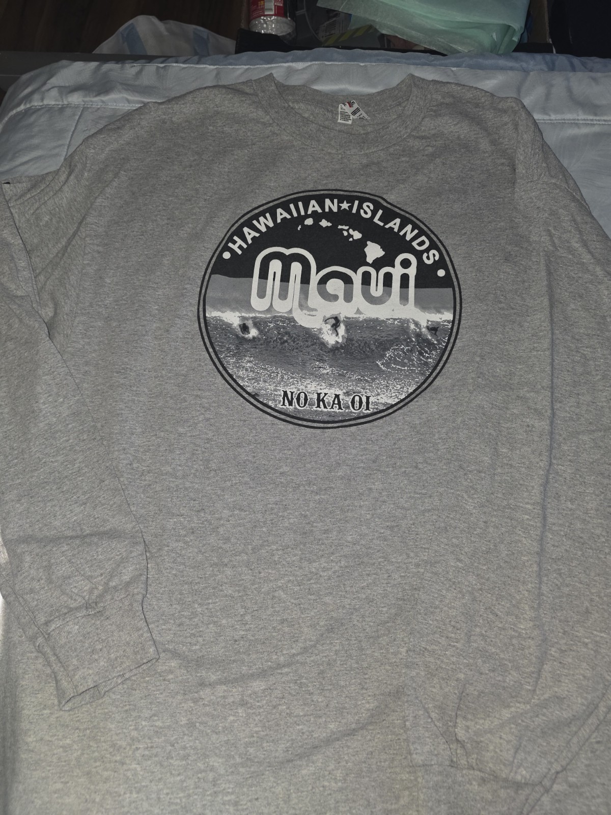 unisex long sleeve tee features a screen-printed “Maui No Ka Oi”