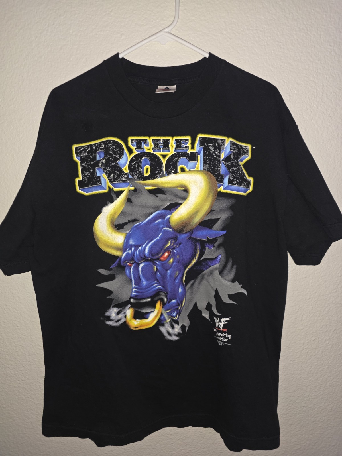 Vintage 2000 (WWF) t-shirt Of Dwayne “The Rock” Johnson on a black cotton tee.
