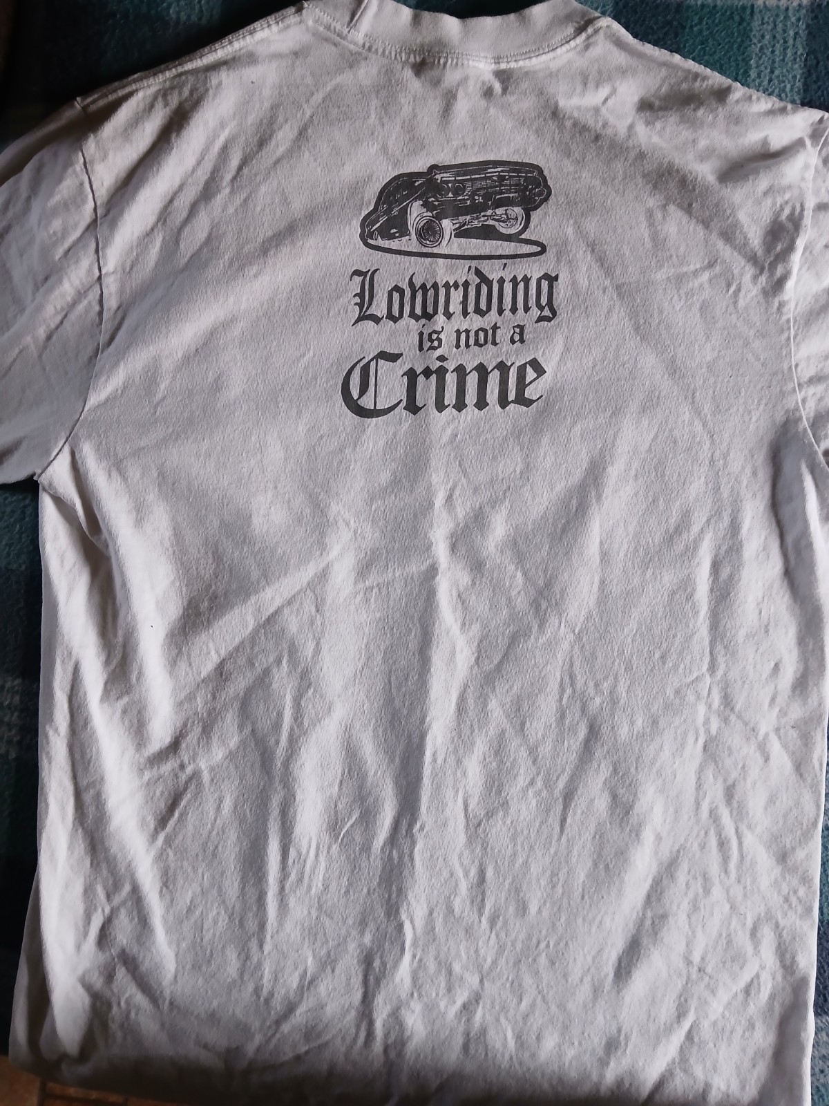 T-Shirt “Lowriding is not a Crime” design printed on a Shaka Wear blank Size L