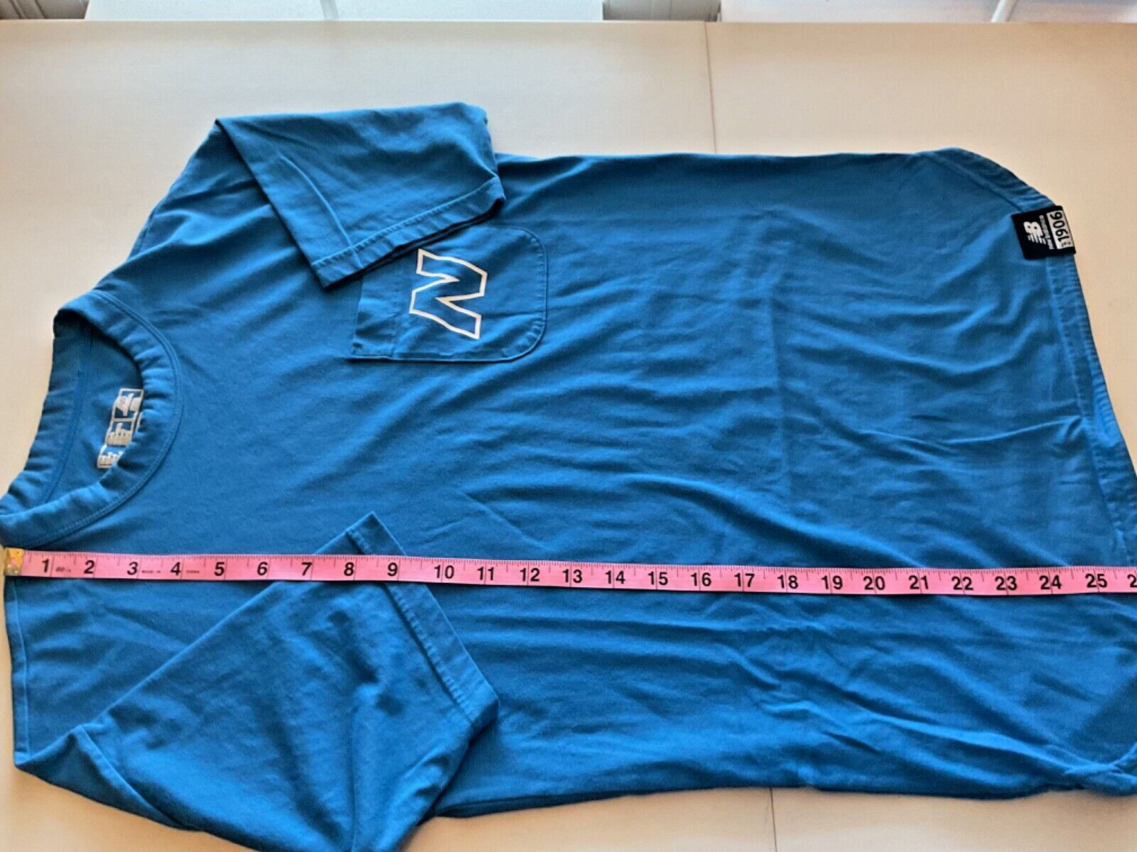 NB New Balance Stretch Blue Pocket T Shirt Unisex size Small Round Slit Hemline