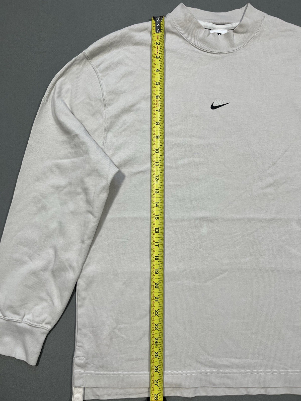 Nike long sleeve mock neck top in Light Bone featuring a small swoosh logo