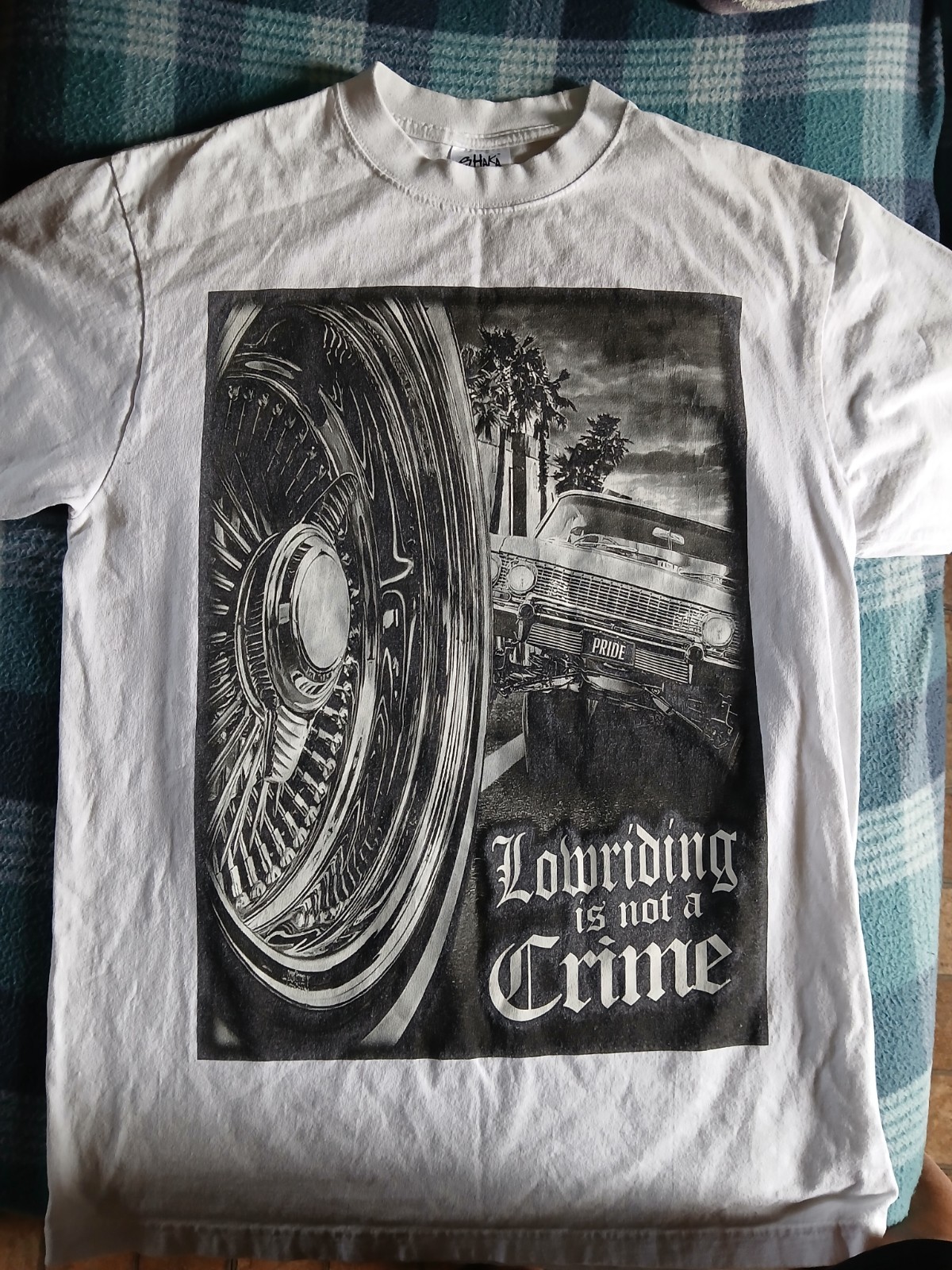 T-Shirt “Lowriding is not a Crime” design printed on a Shaka Wear blank Size L