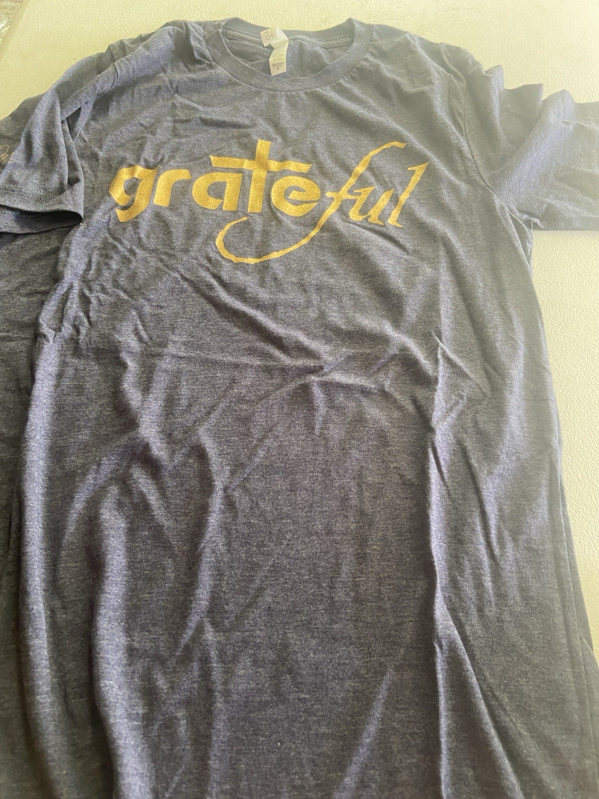 Heather Navy t-shirt with gold “Grateful” logo